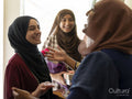 Smiling women meeting for Ramadan celebration at home