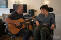 Father playing guitar with disabled son