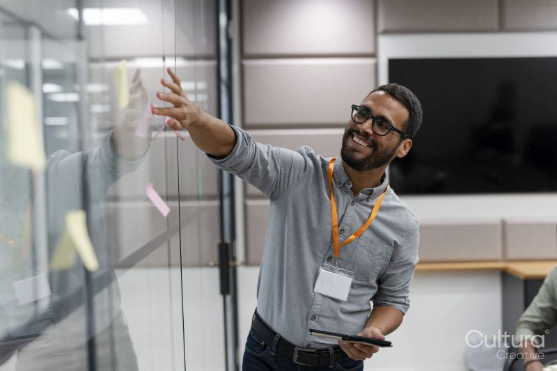 Man using adhesive notes in office