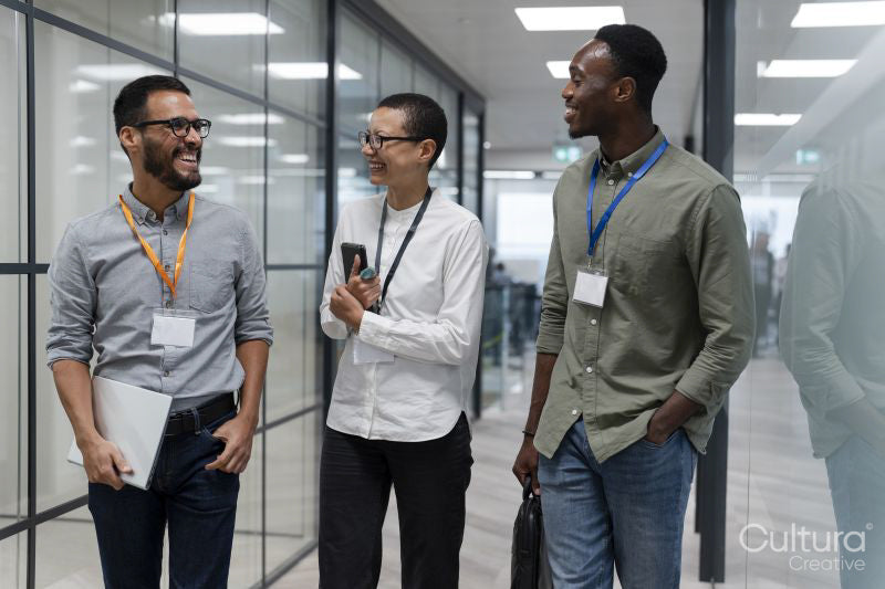 Group of office workers walking together in office corridor