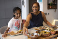Mother and daughter enjoying dinner at home