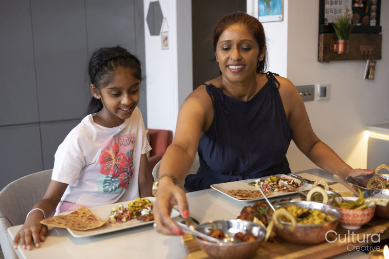 Mother and daughter enjoying dinner at home