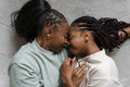 Directly above view of couple embracing while lying on carpet