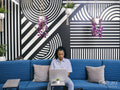 Woman using laptop in office lounge area