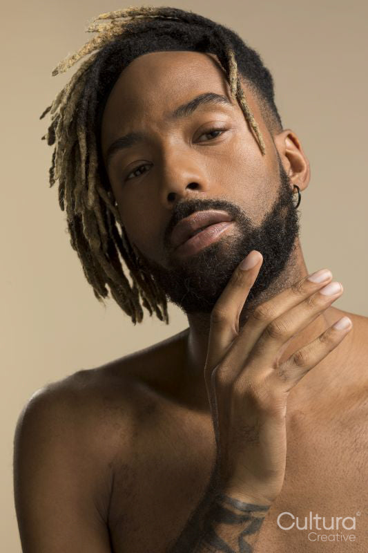 Studio portrait of young man with dreadlocks