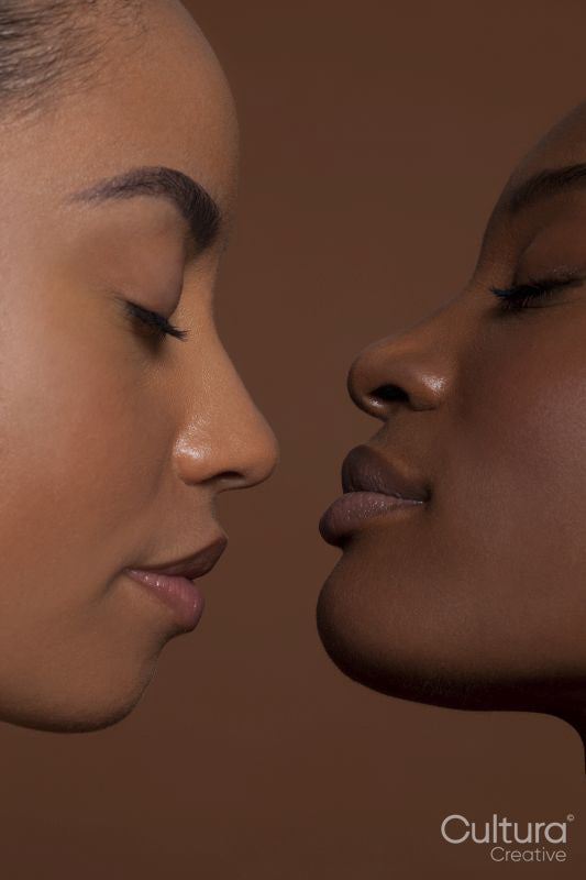 Young women with closed eyes against brown background
