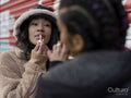 Two young women having fun applying make-up and taking pictures