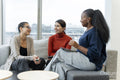 Coworkers having meeting in office lobby