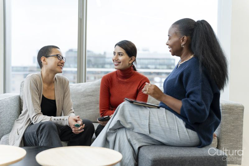 Coworkers having meeting in office lobby