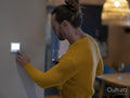 Man adjusting heating at home