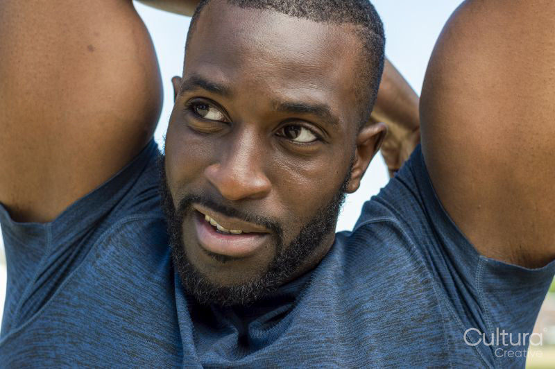 Portrait of mid adult man stretching