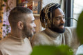 Smiling men looking through window