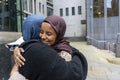 Two young women meeting in city