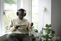 Man with Down syndrome using tablet and wearing headphones