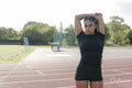 Female athlete stretching arms before training