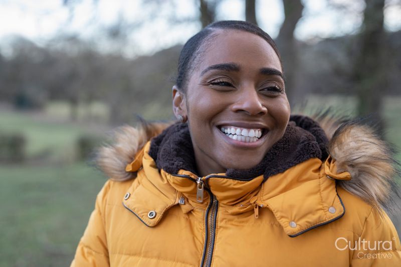 Portrait of woman wearing winter jacket in rural setting