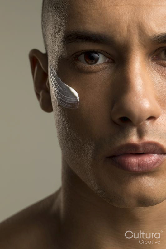 Close-up of man with face cream on cheek