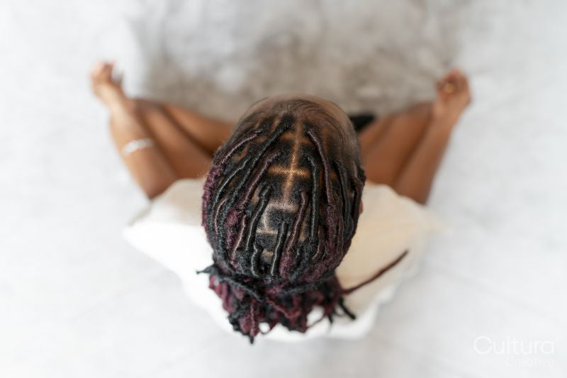 Directly above view of young woman practicing yoga at home