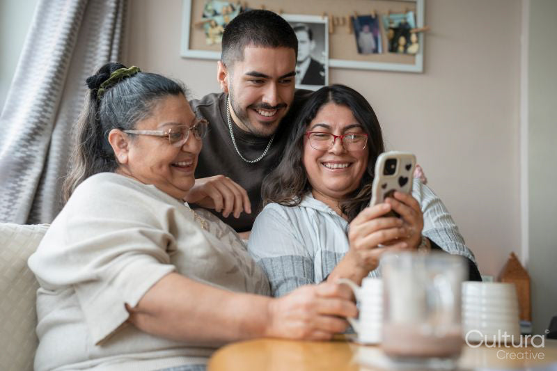 Three-generation family taking selfie at home