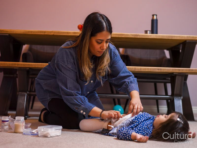 Mother caring for daughter with feeding tube