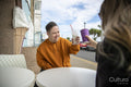 Man and woman toasting at sidewalk cafe table