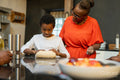 Senior woman with grandson preparing dough