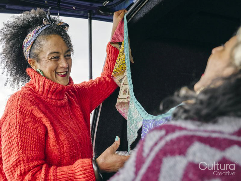 Women hanging decorations in van