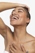 Studio portrait of smiling woman with eyes closed
