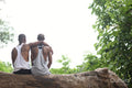 Louisiana, Rear view of couple sitting on log in forest