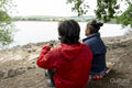 Mother and son relaxing by lake