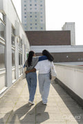 Young female couple walking in city