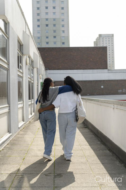 Young female couple walking in city