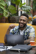 Man sitting in office lounge using laptop