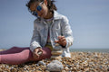 Girl stacking stones on beach