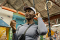 Woman putting on in-ear headphones at gym