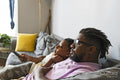Father and daughter watching tv at home
