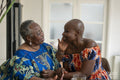 Smiling senior woman touching adult daughters face at home