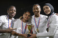 Team of female soccer players celebrating victory