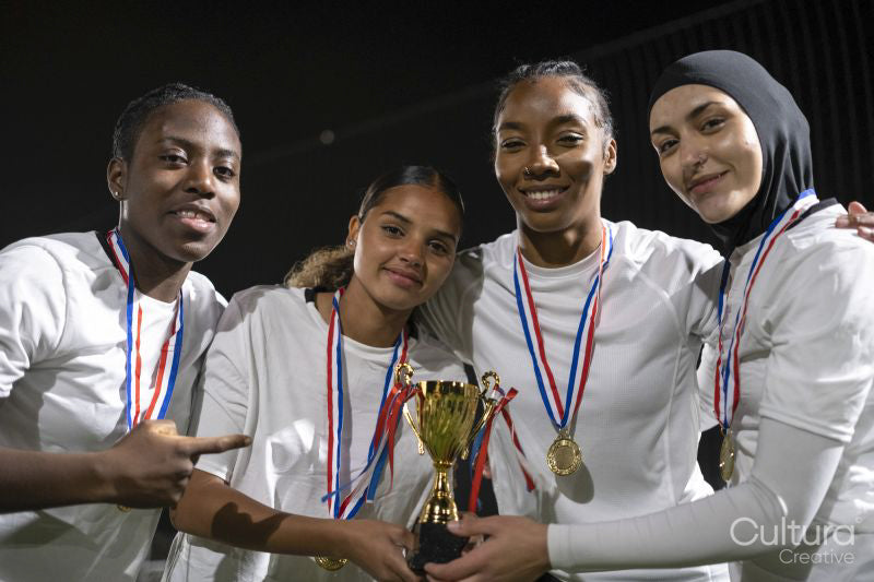 Team of female soccer players celebrating victory