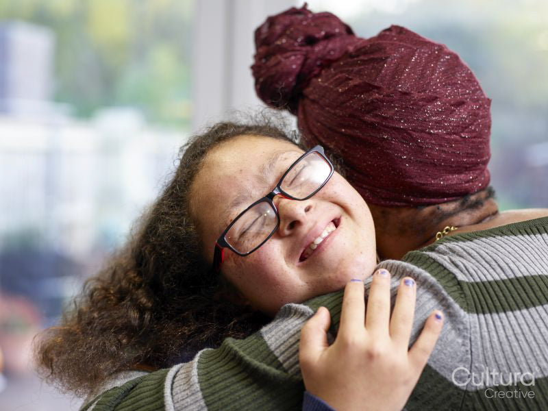 Mother and daughter with Down syndrome hugging