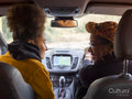 Woman and girl in car, rear view