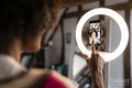 Woman recording video with smart phone at home