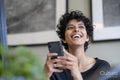 Young woman using smart phone in office