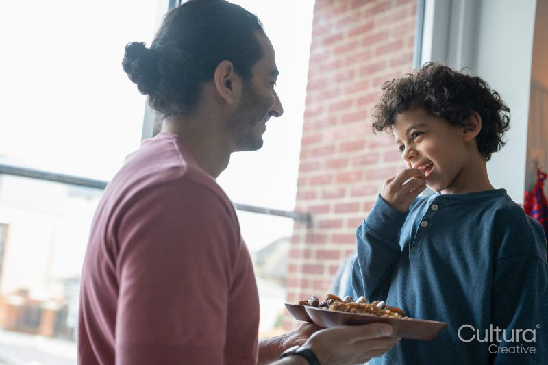 Father and son sharing food