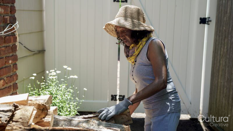 Senior woman sorting firewood