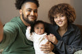 Smiling parents with baby daughter at home