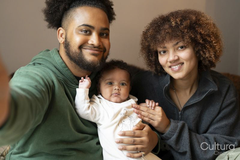 Smiling parents with baby daughter at home