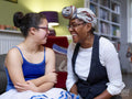 Smiling mother and daughter with Down syndrome in ballerina costume