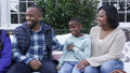 Family with children relaxing on patio