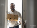 Smiling man bringing pizza home